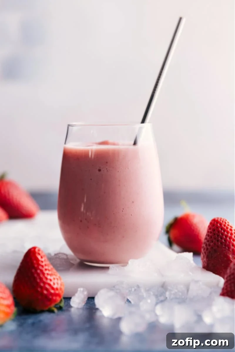 This smoothie shop copycat recipe -- Jamba Juice® Strawberry Wild is made with apple juice, frozen fruit, ice, and some frozen vanilla yogurt. Recipe via ChelseasMessyApron #breakfast #quick #easy #simple #best #healthy #dessert #ice #jambajuice #strawberry #wild #smoothie Jamba Juice Strawberry Wild smoothie, perfectly blended in a glass
