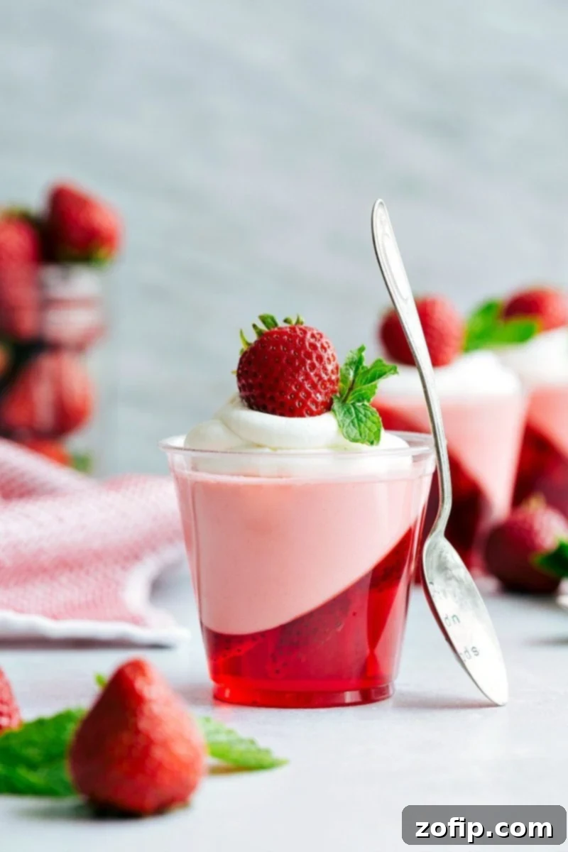Only FIVE ingredients! The coolest and EASIEST hack to make these slanted Jell-O parfait cups with a strawberry mousse on top. Delicious and so easy!