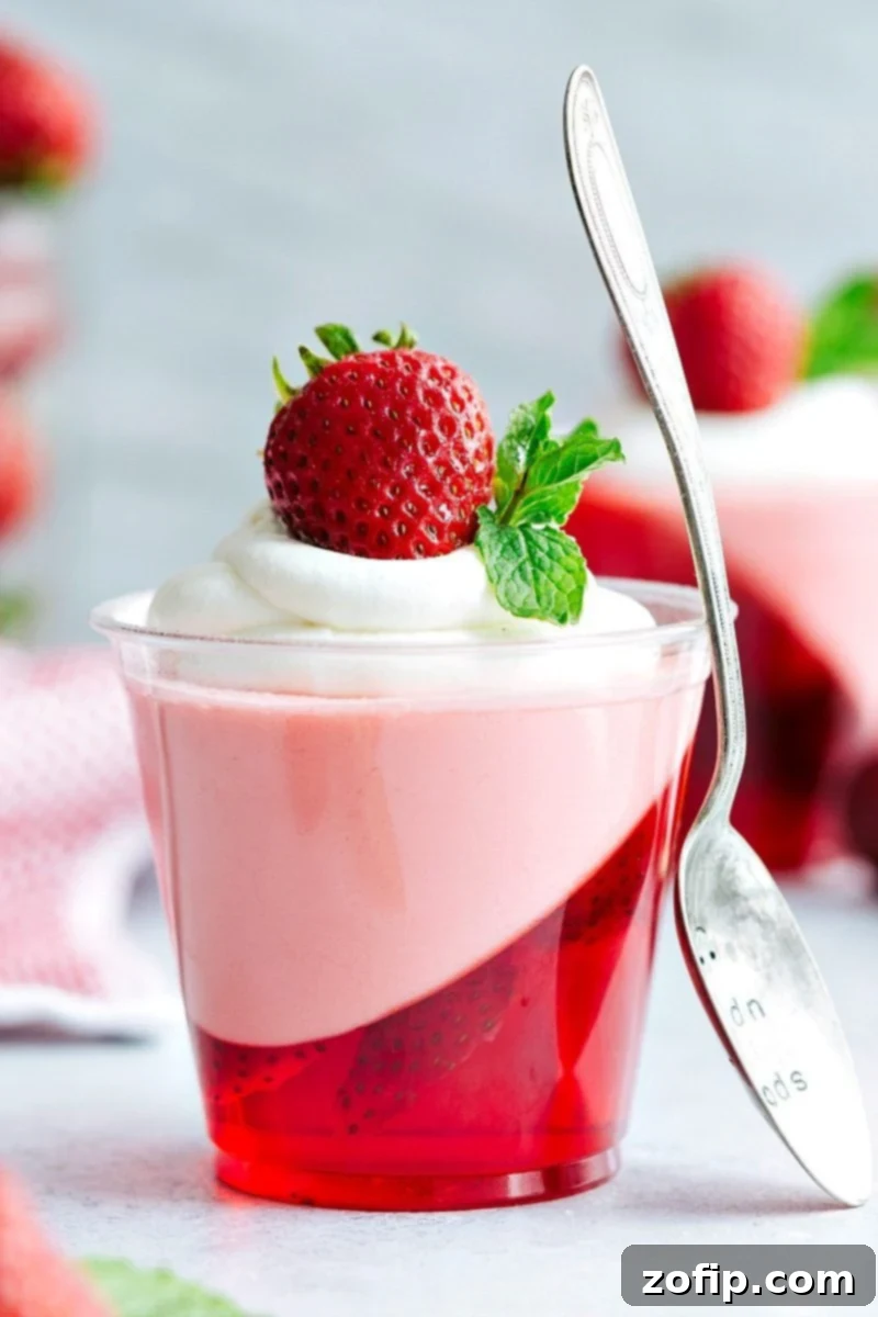 The coolest and EASIEST hack to make these slanted strawberry jell-o parfait cups with a strawberry mousse on top. Delicious and so easy! Via chelseasmessyapron.com