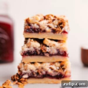 Close-up of a stack of Raspberry Bars showing the distinct layers.