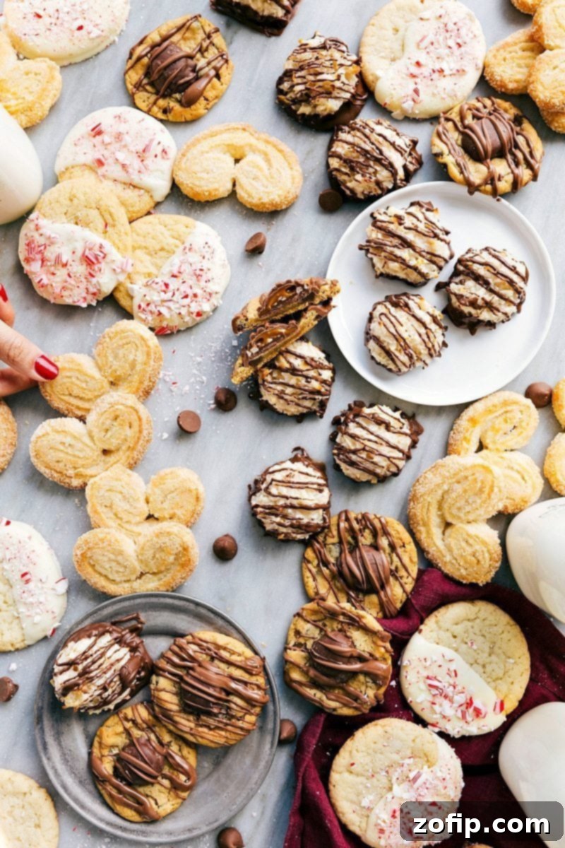Overhead shot of an assortment of 3-Ingredient Christmas Cookies, including turtle, peppermint, palmiers, and macaroons, arranged on a festive holiday platter.