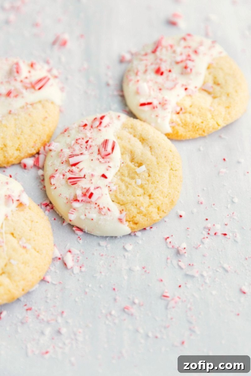 Overhead image of festive White Chocolate Peppermint Cookies on a tray, garnished with crushed candy canes.
