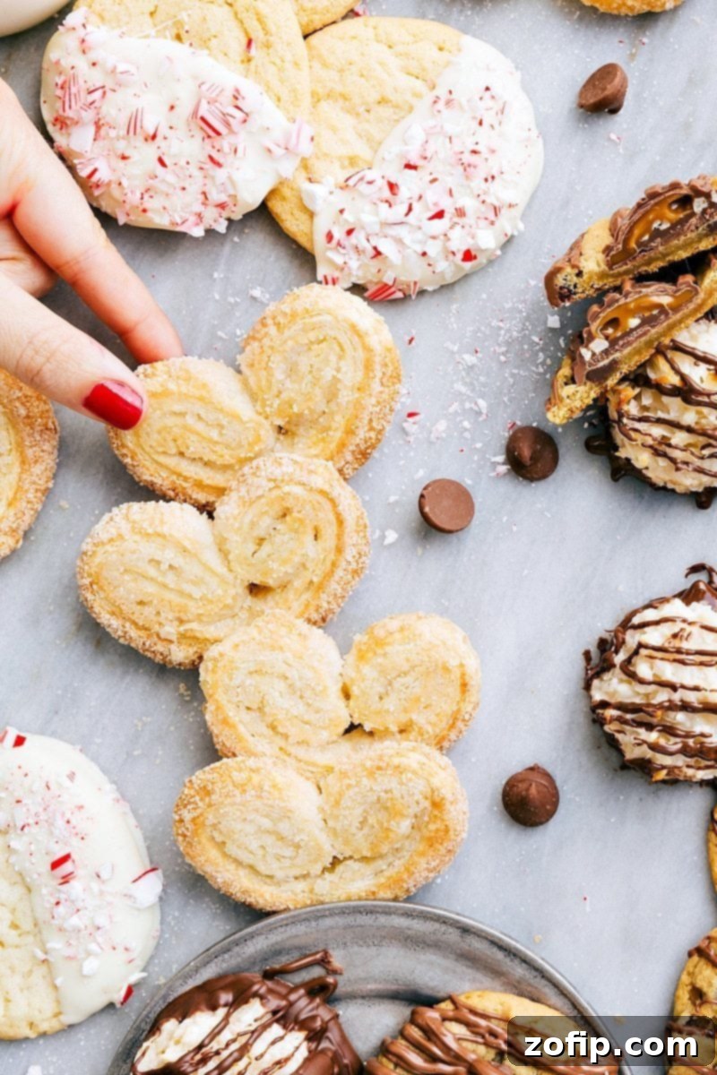 Overhead image showcasing golden-brown Palmiers alongside other 3-ingredient Christmas cookies.