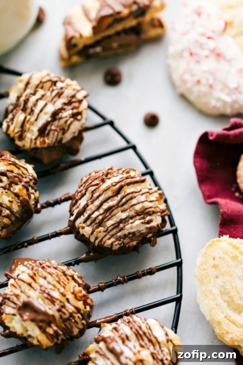 Overhead image of a tray filled with golden-brown coconut macaroons, some with optional chocolate drizzle.