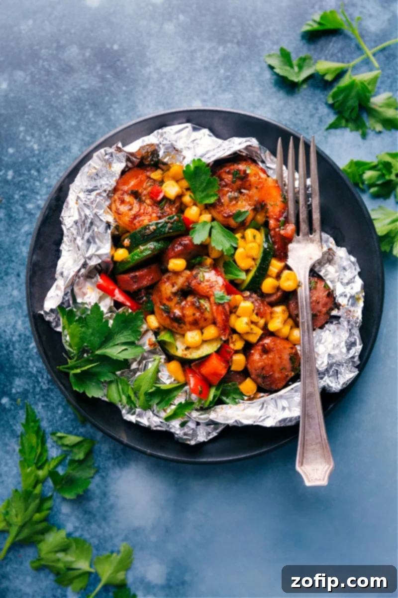 Shrimp Foil Packets: A vibrant mix of well-seasoned vegetables, smoked sausage, and juicy shrimp cooked in individual foil packs.