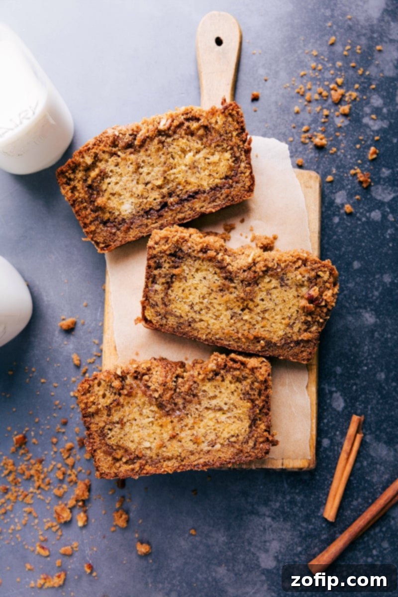 The best cinnamon banana bread cut into slices revealing a delicious cinnamon swirl and moist texture.