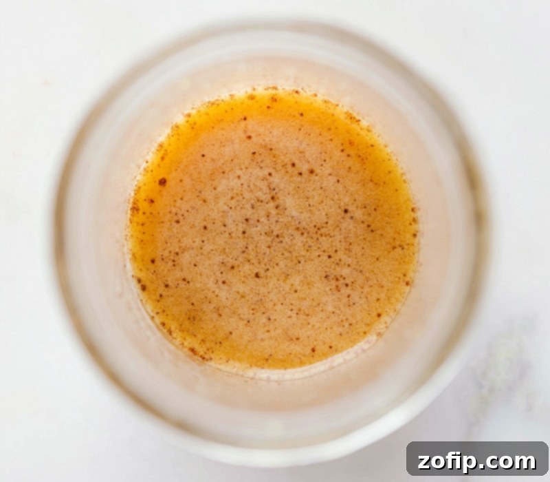 Apple cider vinaigrette dressing in a mason jar, perfectly emulsified and ready to be drizzled over your salad.