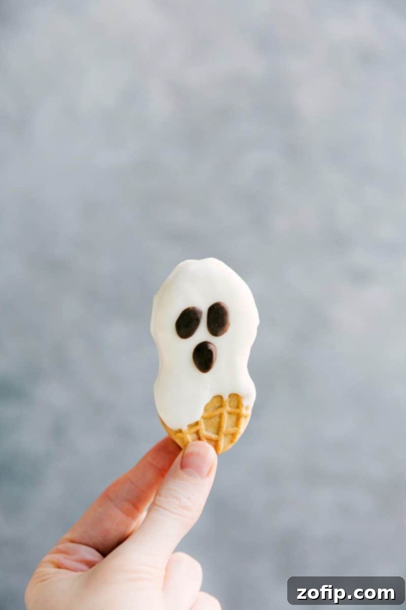 Adorable Nutter Butter Ghost Cookies dipped in white chocolate with chocolate chip eyes and mouth, an easy Halloween treat.