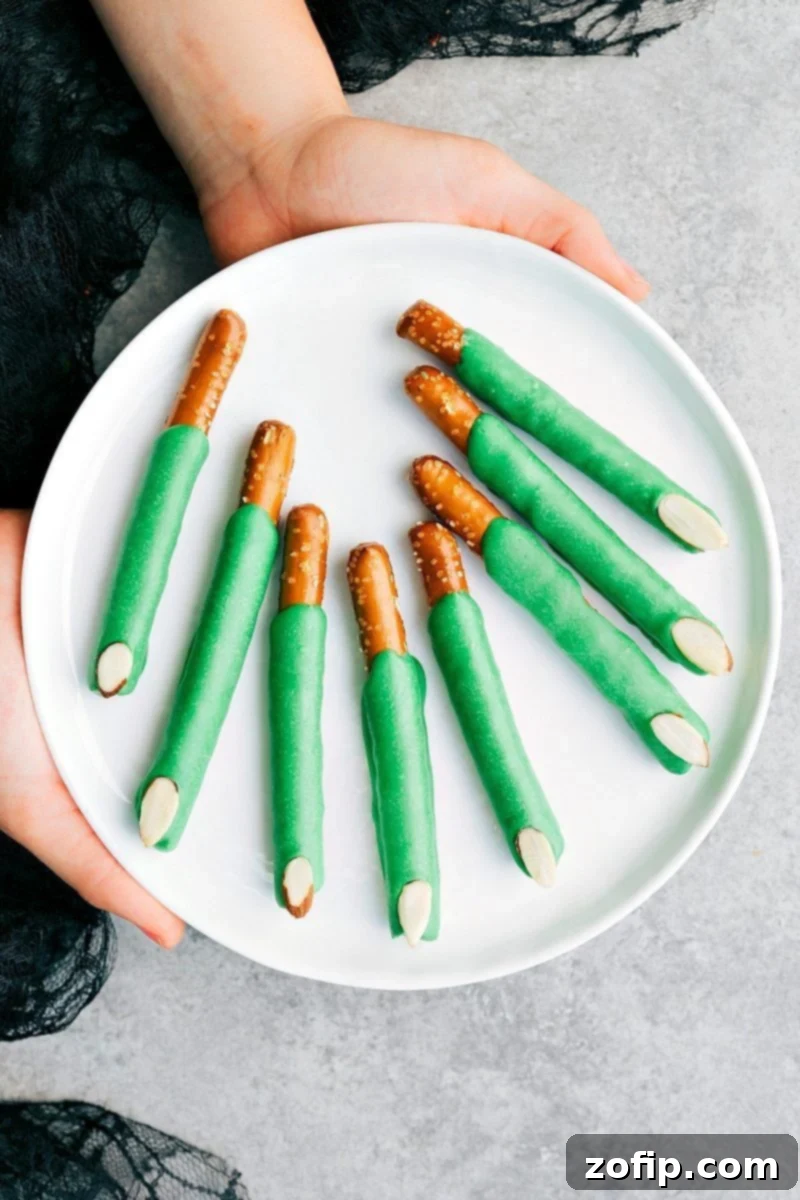Creepy and fun Witch Finger Pretzels made with green candy melts and almond slivers, a perfect Halloween snack.