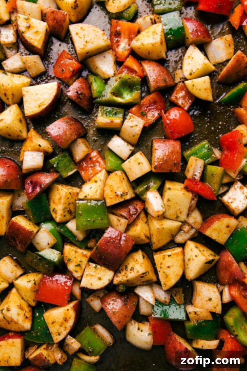 Sheet Pan Bacon Potato Roast 5 Close-up of a generous serving of crispy roasted red potatoes and bacon on a plate, highlighting the texture and color.