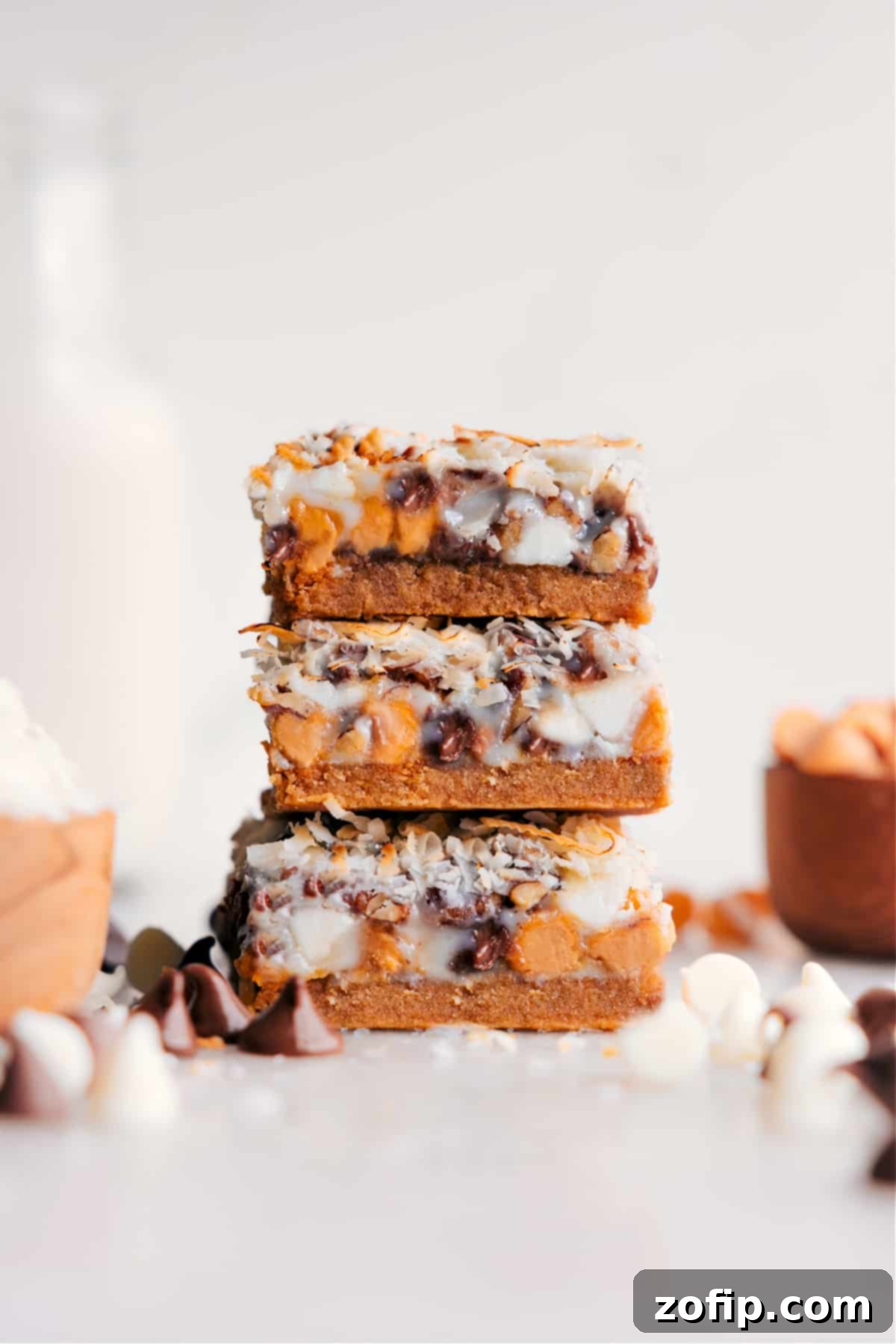 The Ultimate Dessert: Perfectly Sliced 7 Layer Bars Perfectly cut squares of the best 7 Layer Bars, showcasing the irresistible layers and ready to be enjoyed as the ultimate dessert.