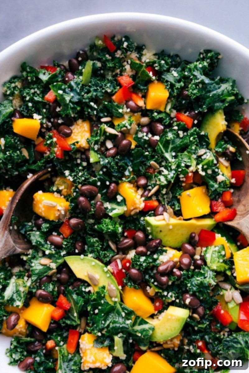 Fresh and Flavorful Kale Couscous Salad Ready to Serve A beautifully presented bowl of freshly made Kale Couscous Salad, garnished and ready to be served. The vibrant colors of kale, couscous, mango, and red pepper are prominent.