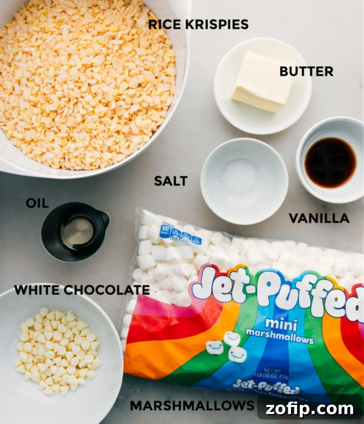 Ingredients In The Best Rice Krispie Treats All essential ingredients for the best Rice Krispie Treats recipe laid out: crispy rice cereal, unsalted butter, miniature marshmallows, vanilla extract, and salt, plus white chocolate chips and oil for an optional drizzle.