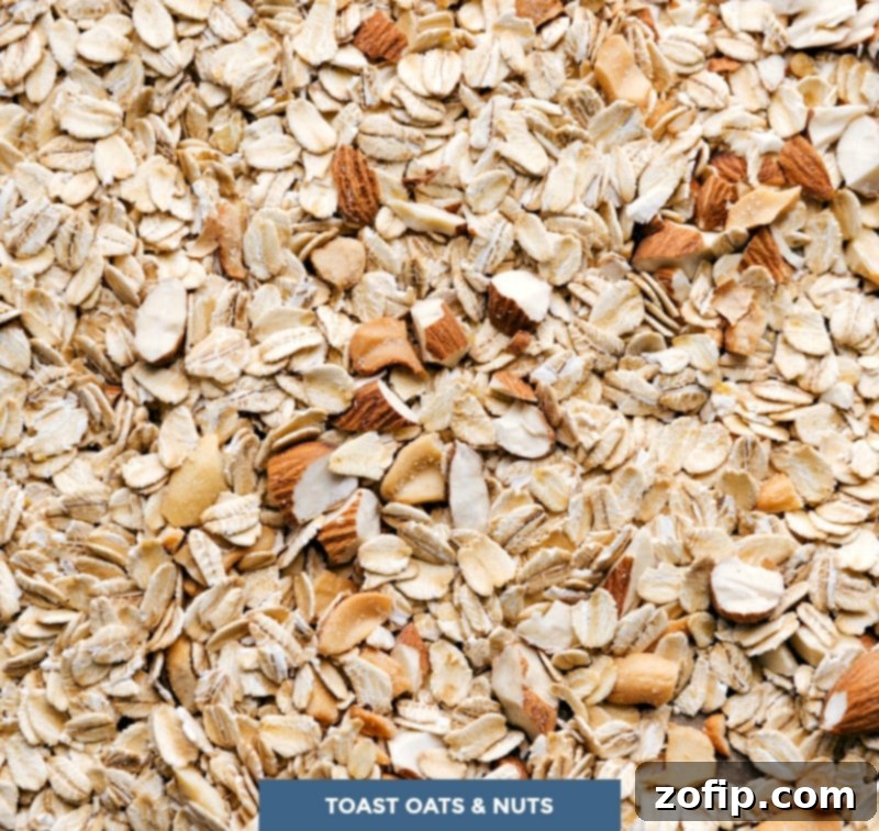 Oats and nuts, the key ingredients used in the recipe, arranged and ready to be toasted in the oven.
