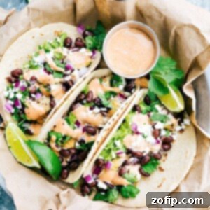 Delicious BBQ Chicken Tacos with melted cheese, fresh lettuce, and zesty lime