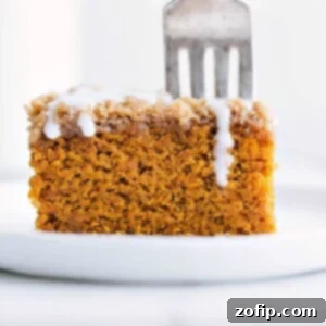 Delicious slice of pumpkin coffee cake with icing on top ready to be enjoyed.