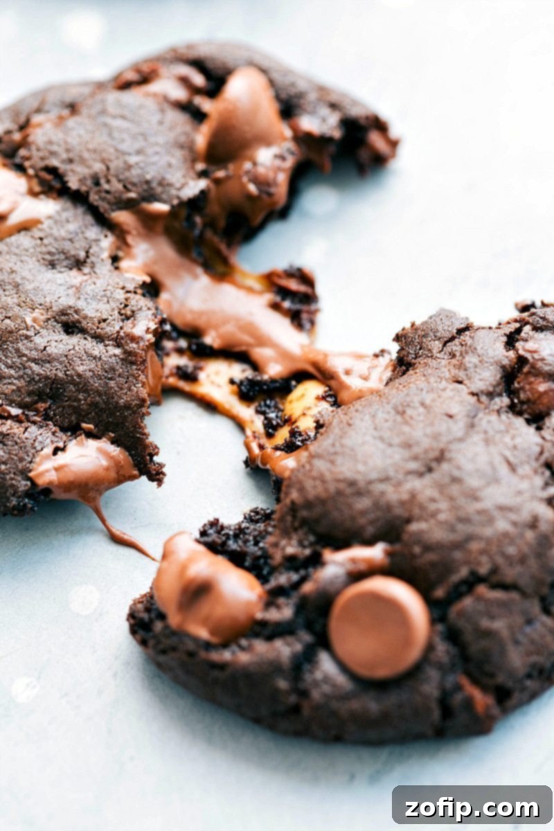 Gooey Caramel Center of a Chocolate Caramel Cookie A chocolate caramel cookie split in half, revealing the gooey Rolo caramel center and melted chocolate chips