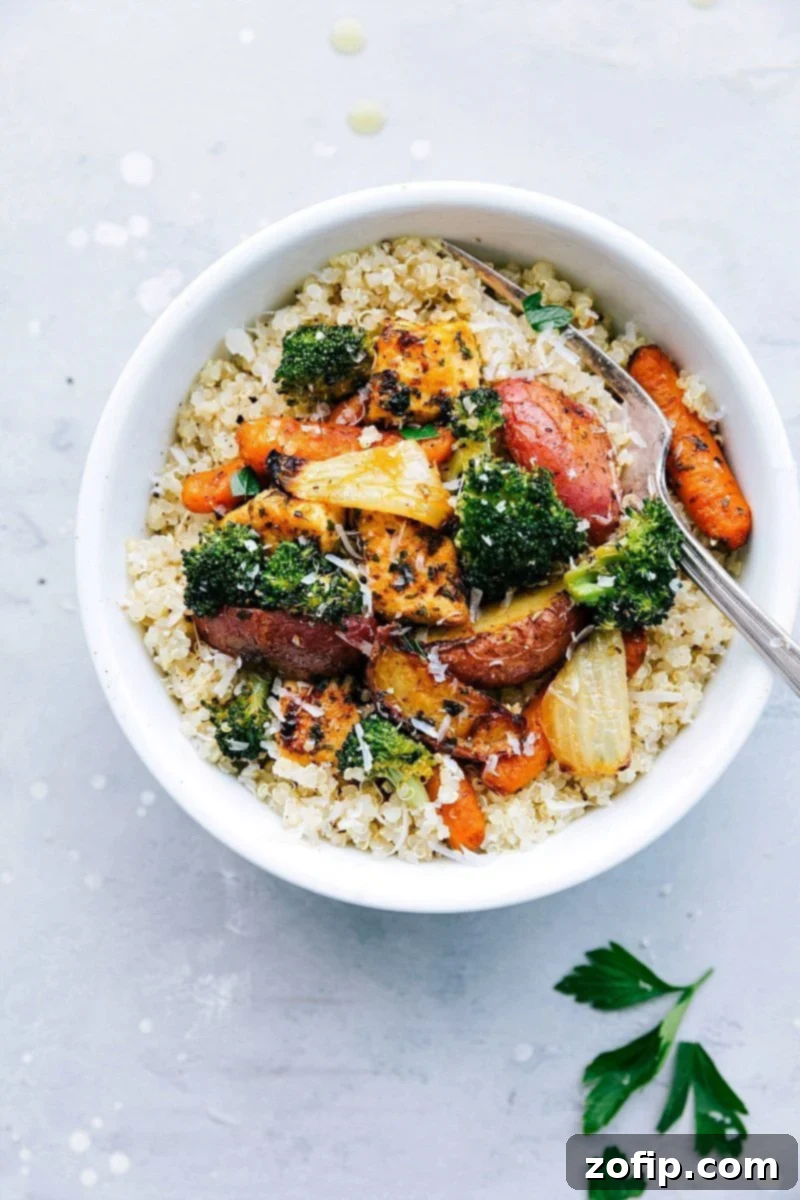 Roasted chicken and vegetables served over a bed of quinoa, highlighting its meal prep versatility.