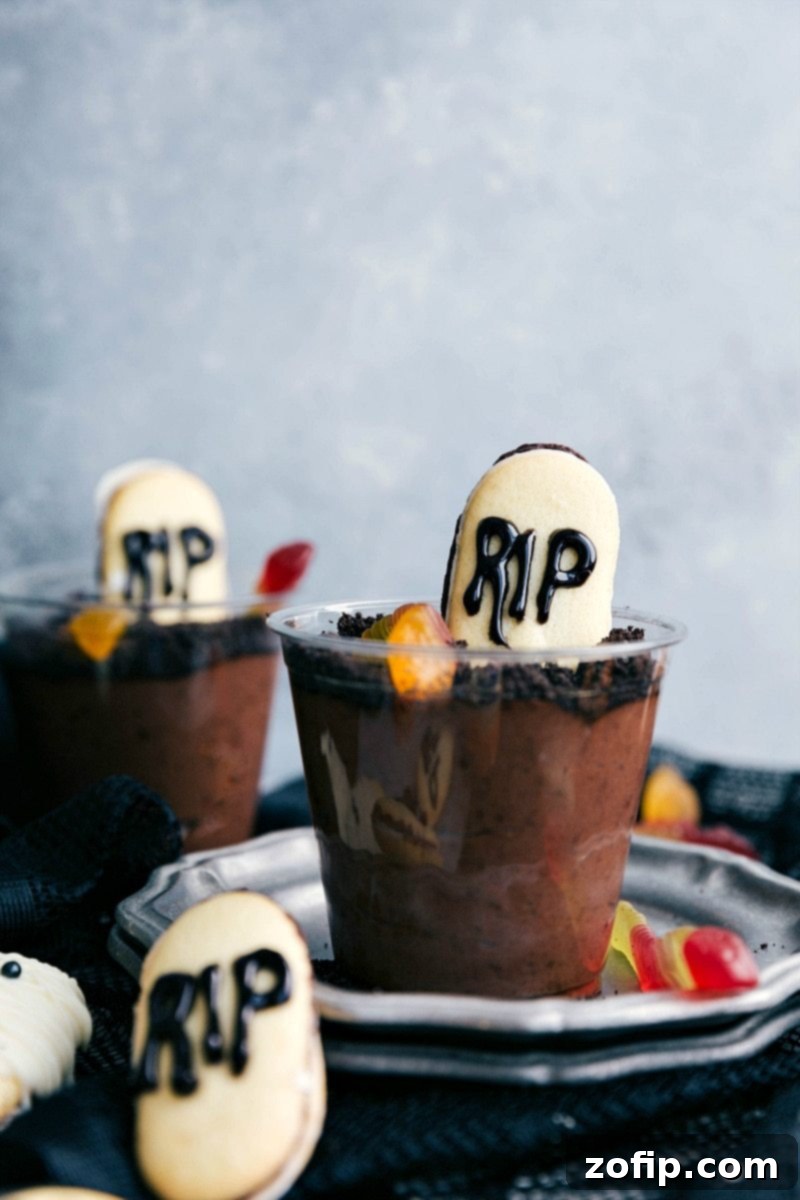 Graveyard Pudding Cups - Fun Halloween Dessert Spooky Graveyard Pudding Cups with crushed cookies and tombstone Milano cookies.