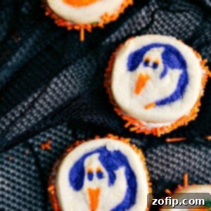 Ghoulish Goodies 5 Double-sided Halloween sandwich cookies with pumpkin and ghost designs.