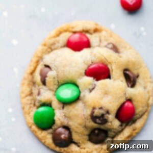 Homemade M&M Cookie Mix Jars 2 A top-down view of freshly baked M&M Christmas Cookies, golden brown with vibrant M&M candies and chocolate chips.