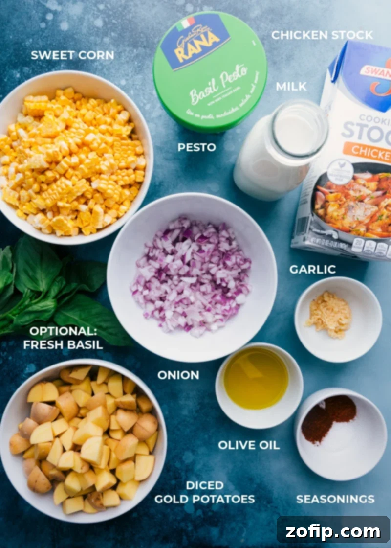All the fresh ingredients laid out for Potato Corn Chowder: sweet corn on the cob, diced red onion, Yukon potatoes, olive oil, garlic, seasonings, and fresh basil.