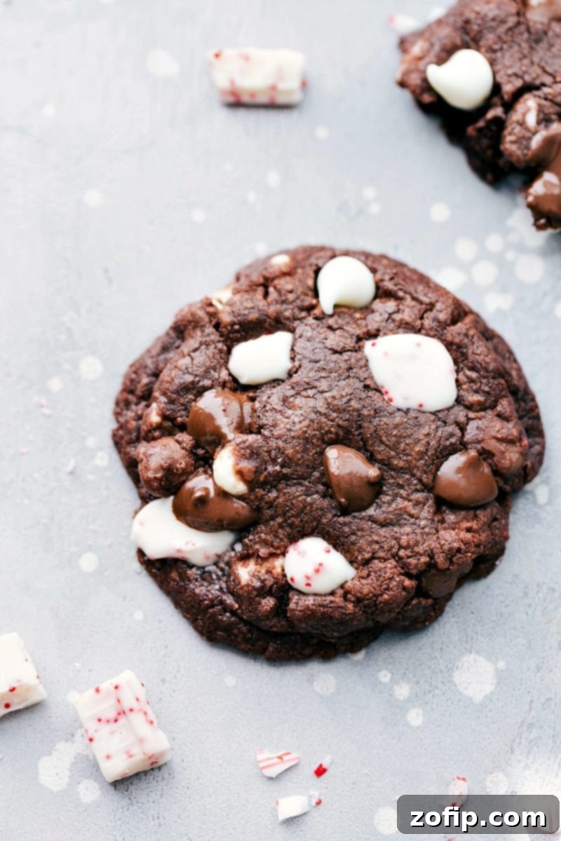 Close-up of a freshly baked, fudgy peppermint bark cookie, still warm from the oven.