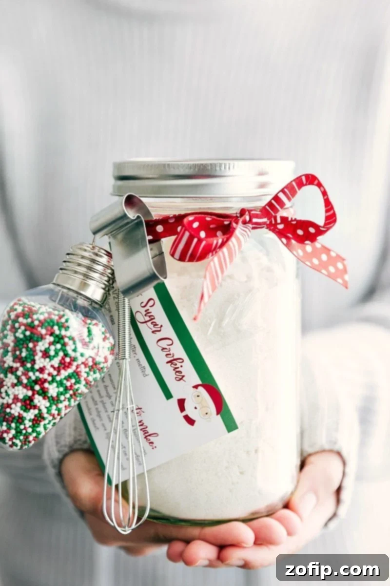 Mason Jar Cookie Delights 2 Beautifully layered Christmas Mason Jar Sugar Cookie mix with festive decorations, ready for gifting.