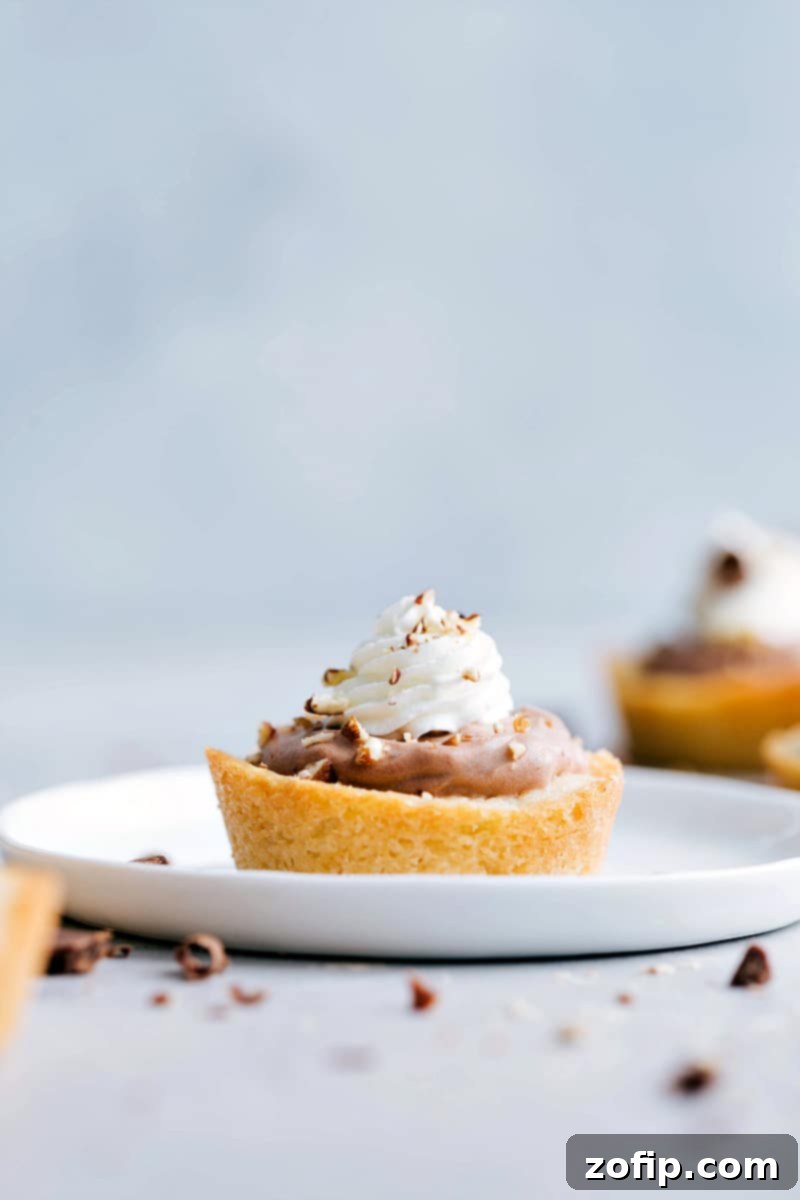 Delicious Sugar Cookie Turtle Pudding Bites with caramel, chocolate pudding, whipped cream, and pecans