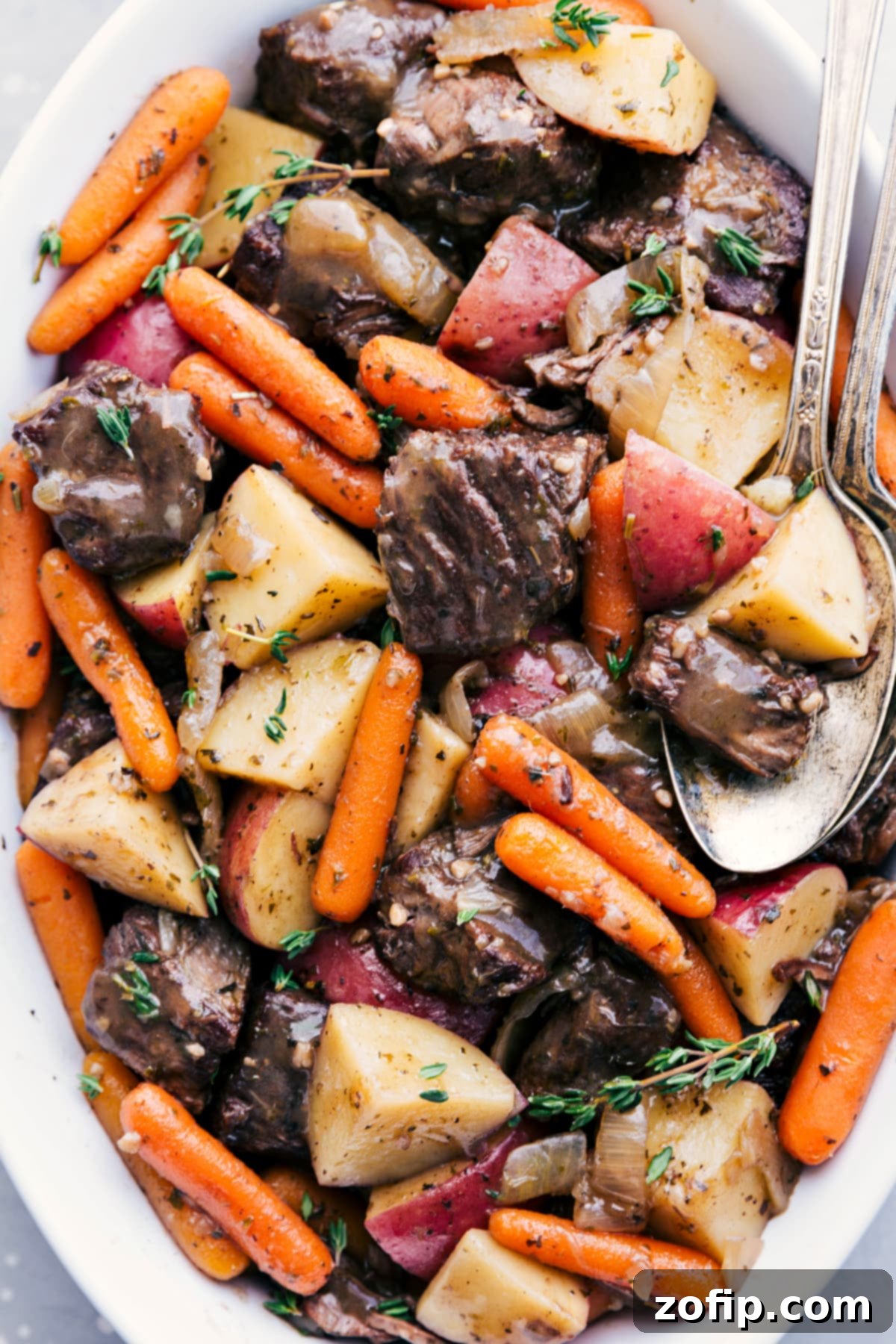 The Best Crockpot Roast Recipe for Tender Beef A succulent crockpot roast recipe, fresh from the slow cooker, garnished with fresh herbs and ready to serve in a rustic dish.