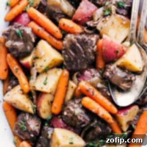 Slow Cooker Pot Roast Perfection 3 A steaming serving of homemade crockpot roast, showcasing tender beef, colorful vegetables, and rich gravy.