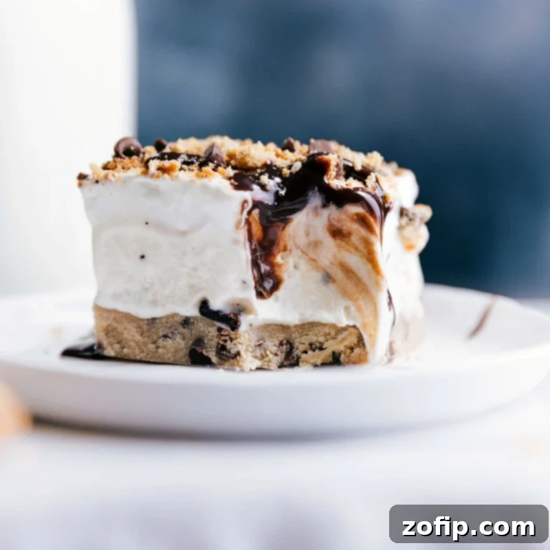 Irresistible Cookie Dough Ice Cream Bar: A Tempting Frozen Delight A close-up of a delicious Cookie Dough Ice Cream Bar with a bite taken, revealing the luscious layers of edible cookie dough, creamy ice cream, whipped cream swirls, and chocolate chips.