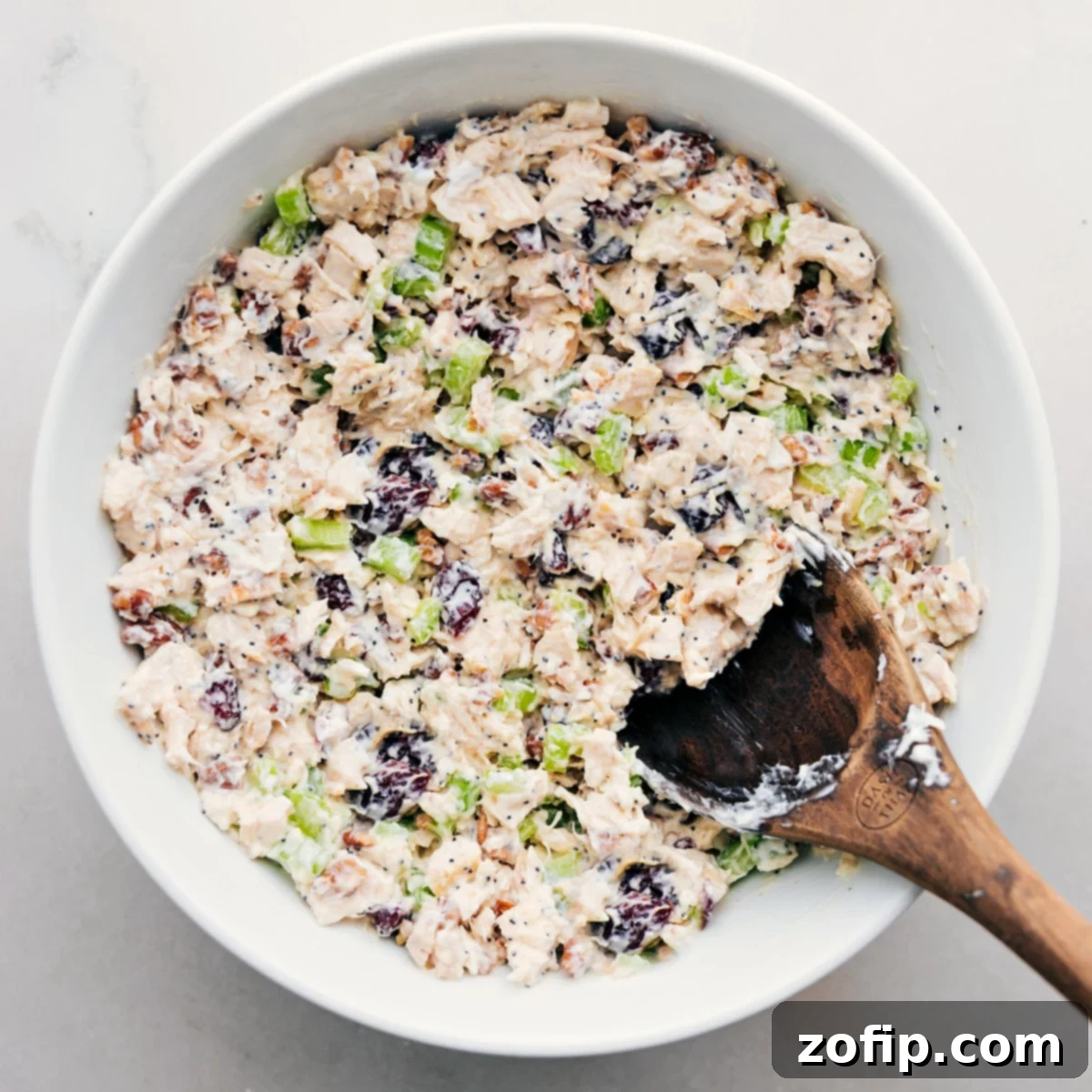The chicken salad perfectly mixed in a decorative bowl, garnished and ready to be served alongside crisp lettuce, fresh bread, or other favorite accompaniments.