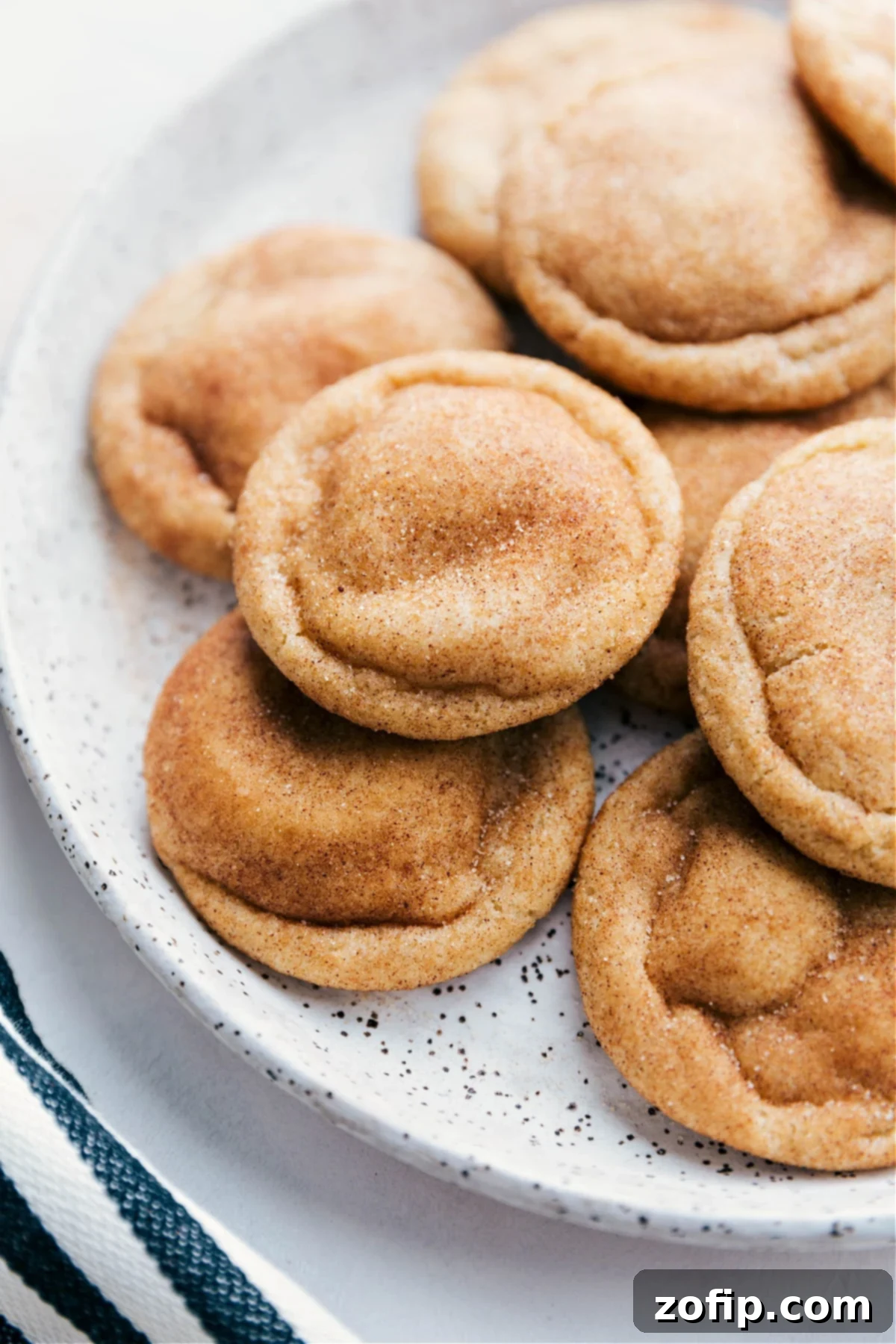 Freshly Baked Snickerdoodle Cookies Ready to Enjoy Snickerdoodle cookies arranged on a plate, fresh out of the oven, warm and inviting with a golden-brown exterior, dusted with cinnamon sugar, and packed with the best flavor.