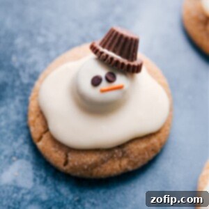 Close-up of a Melted Snowman Cookie with a perfect peanut butter base, white chocolate topping, and candy decorations.