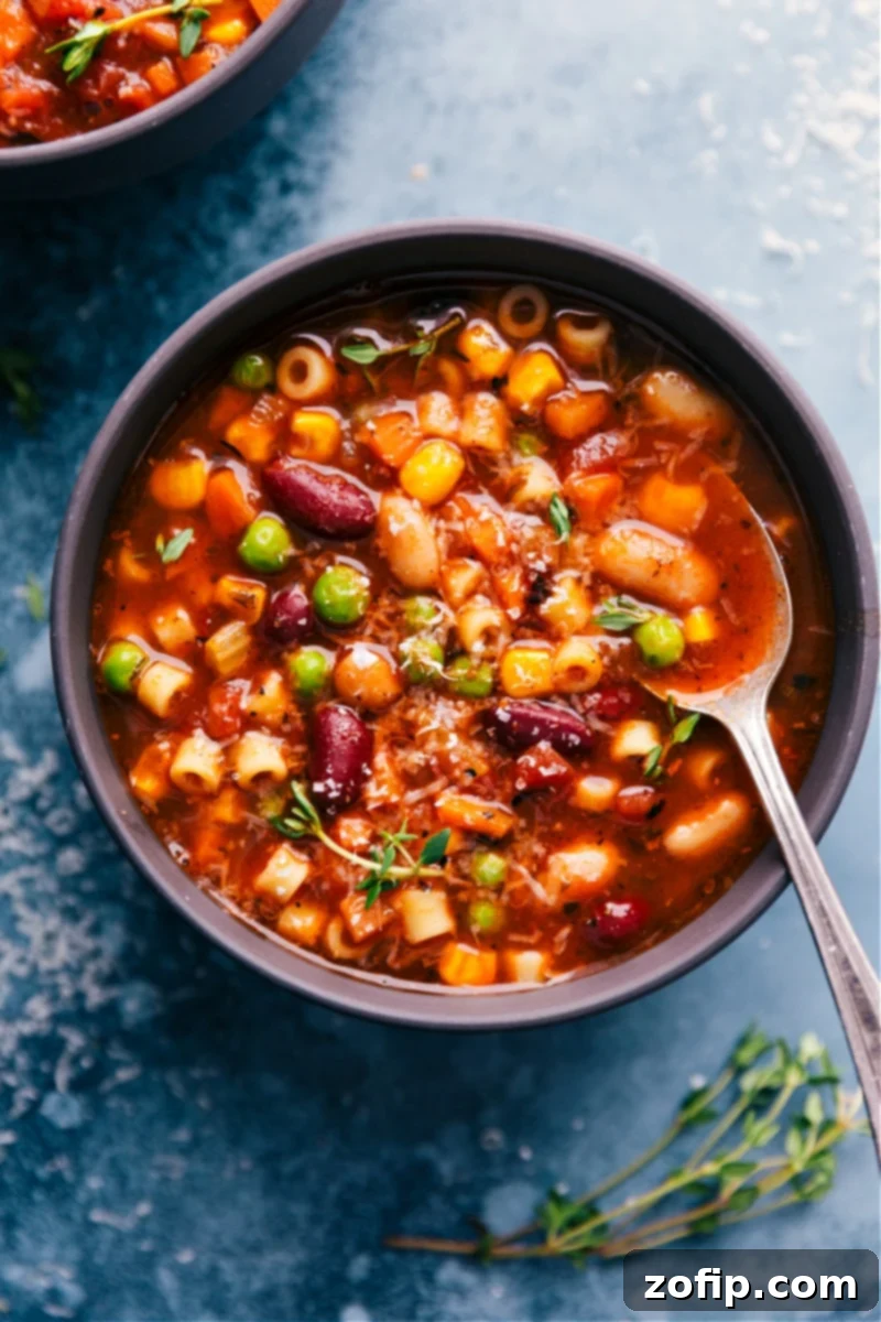 A steaming bowl of homemade Olive Garden Minestrone Soup, brimming with colorful vegetables and ditalini pasta, ready to be enjoyed.