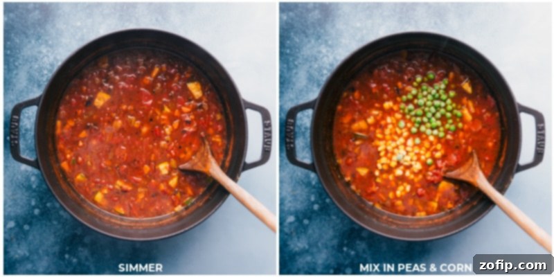 The Olive Garden Minestrone Soup simmering gently in a large pot, with vibrant peas and corn being stirred in to complete the dish.
