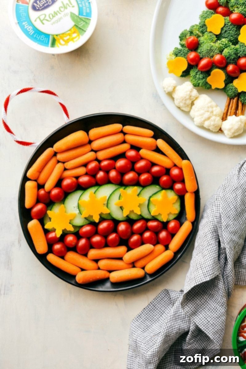 A beautiful holiday appetizer featuring fresh vegetables arranged in a circular pattern to resemble a Christmas ornament, accompanied by a flavorful dip.