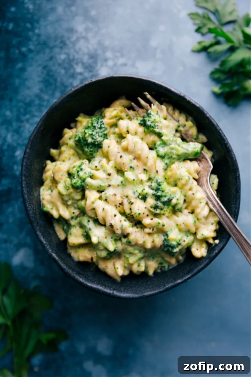 A bowl of Broccoli Pasta with a fork resting beside it, ready to be enjoyed