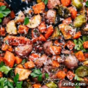 Golden Roasted Vegetables 3 Beautifully roasted mixed vegetables on a sheet pan, garnished with herbs and parmesan