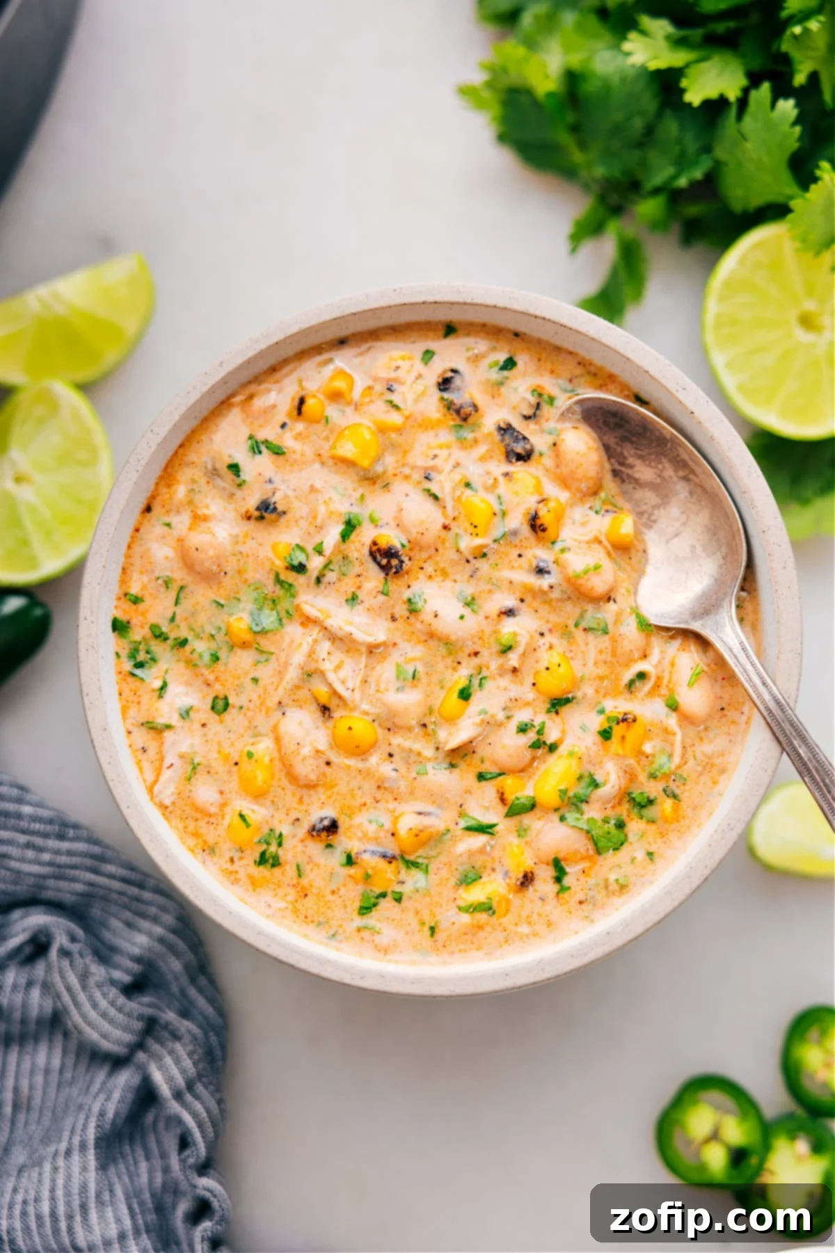 The Best And Easiest Crockpot White Chicken Chili Recipe A bowl of Crockpot White Chicken Chili garnished with fresh toppings, ready to eat.