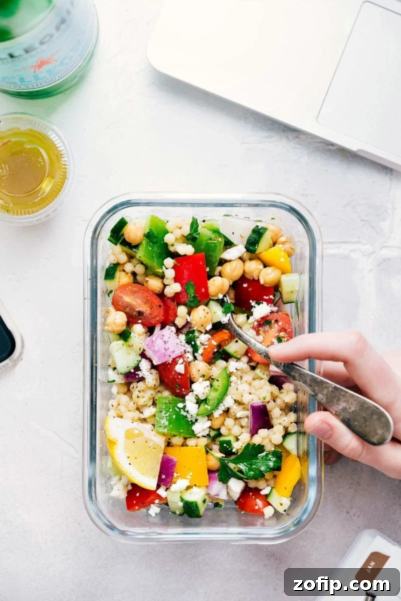 Greek couscous salad in a meal prep container ready to be enjoyed.