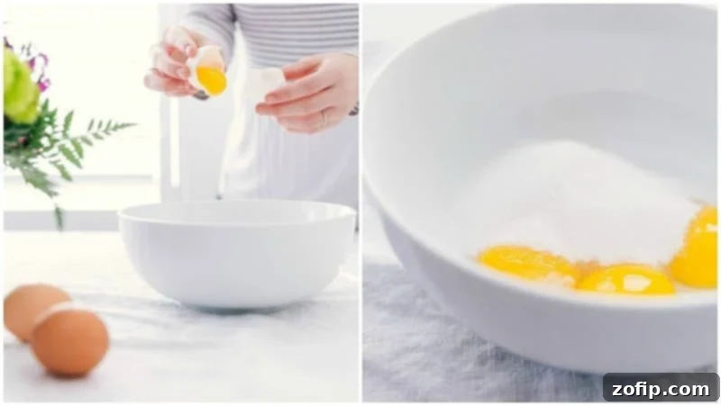 A close-up shot showing egg yolks being separated into a bowl, with granulated sugar carefully added on top, illustrating a key step in Crème Brûlée preparation.