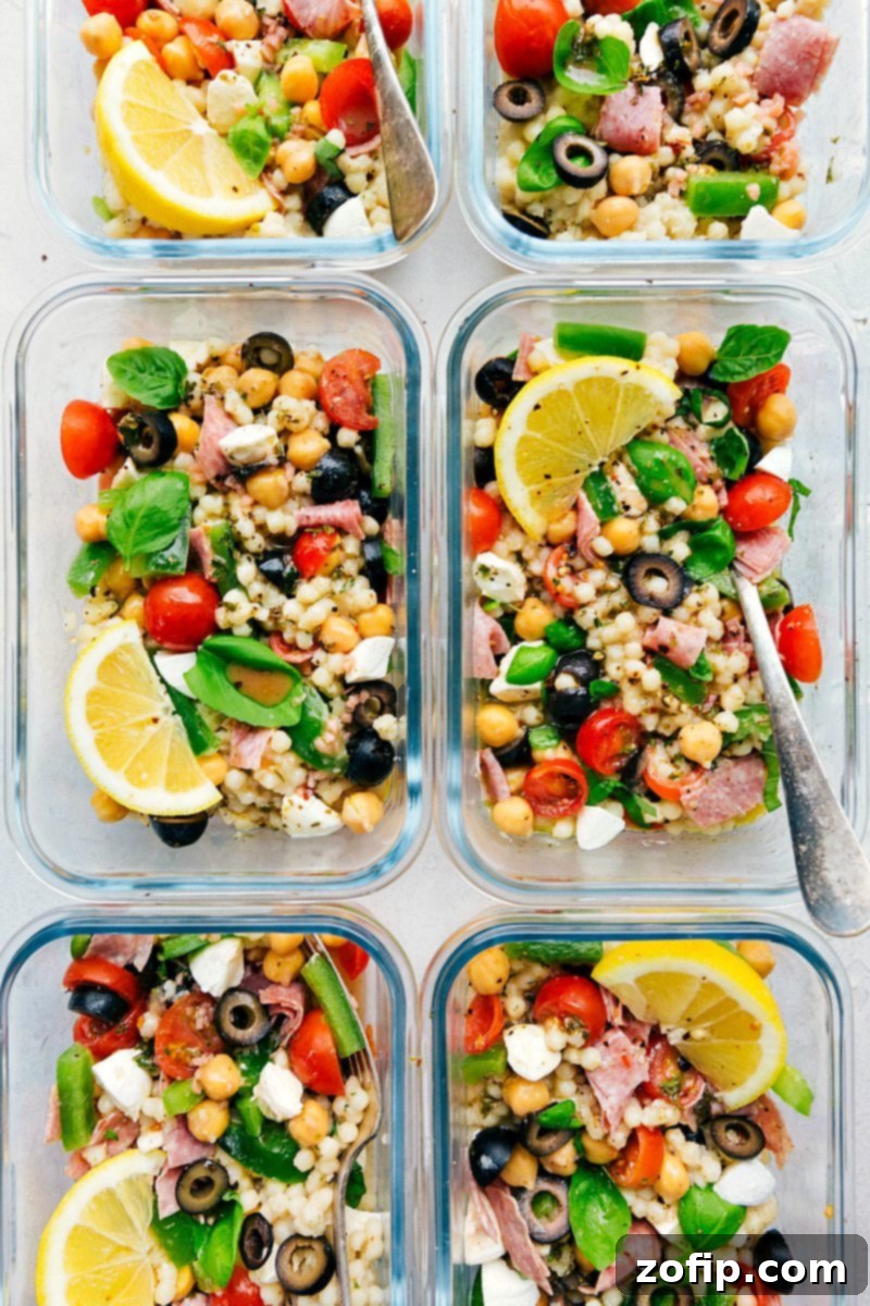 Meal Prep Italian Couscous Salad 4 Close-up shot of a colorful Italian Couscous Salad, showing the texture of couscous, chopped vegetables, and pieces of salami and mozzarella, ready for serving.