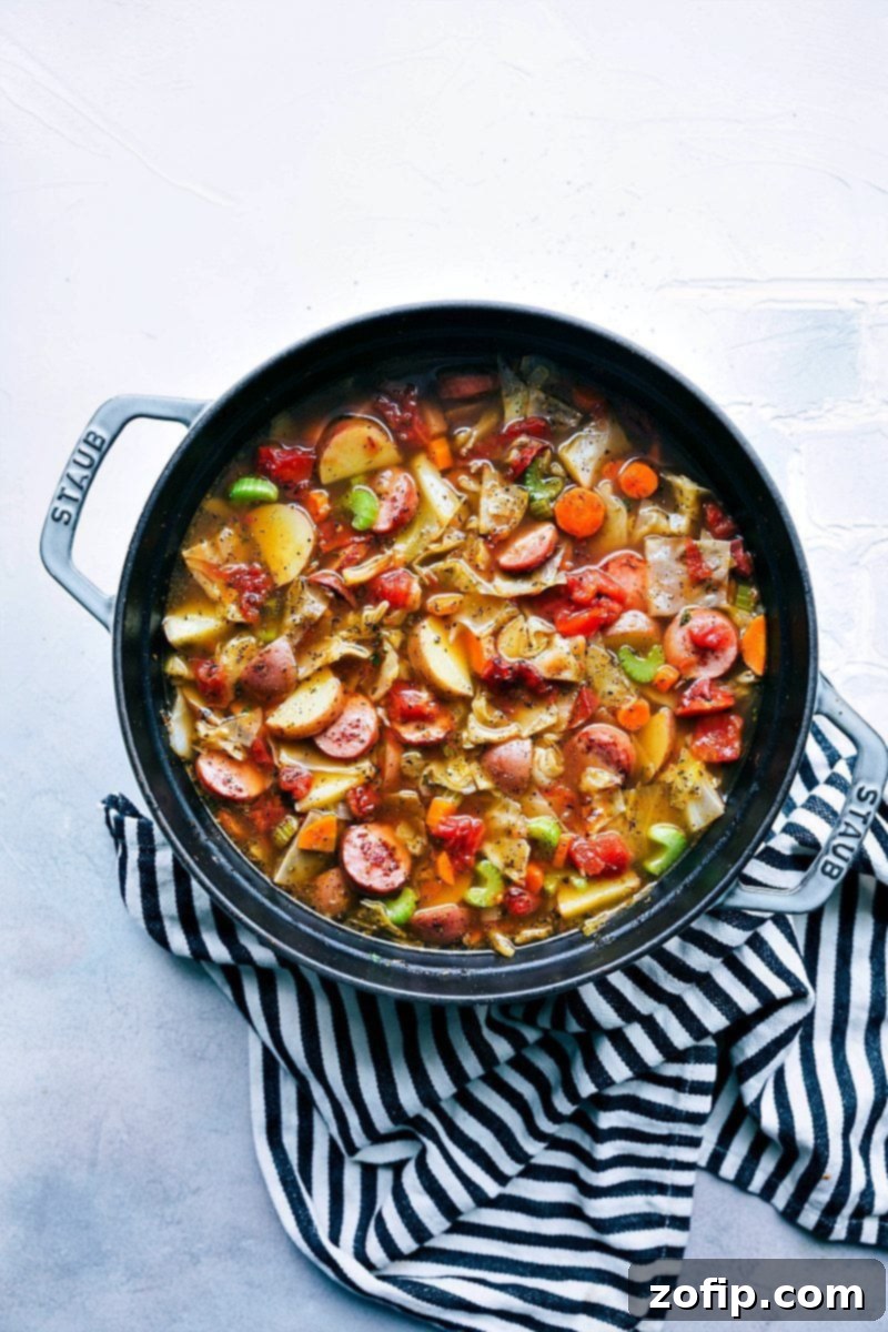 A thick and hearty sausage, potato, and cabbage soup; a healthy recipe that is packed with flavorful ingredients! chelseasmessyapron.com | #cabbage #soup #sausage #healthy #easy #quick #cabbagesoup #celery #carrots #potatoes