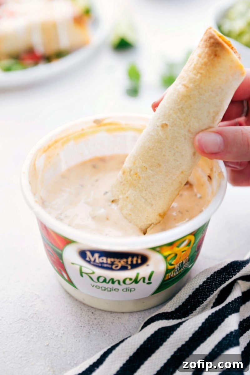 A bowl of creamy, spiced chicken filling for taquitos, ready to be spread onto tortillas.