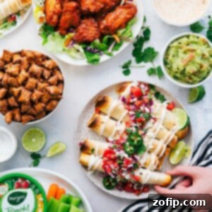 Baked Chicken Taquitos with various toppings on a platter.