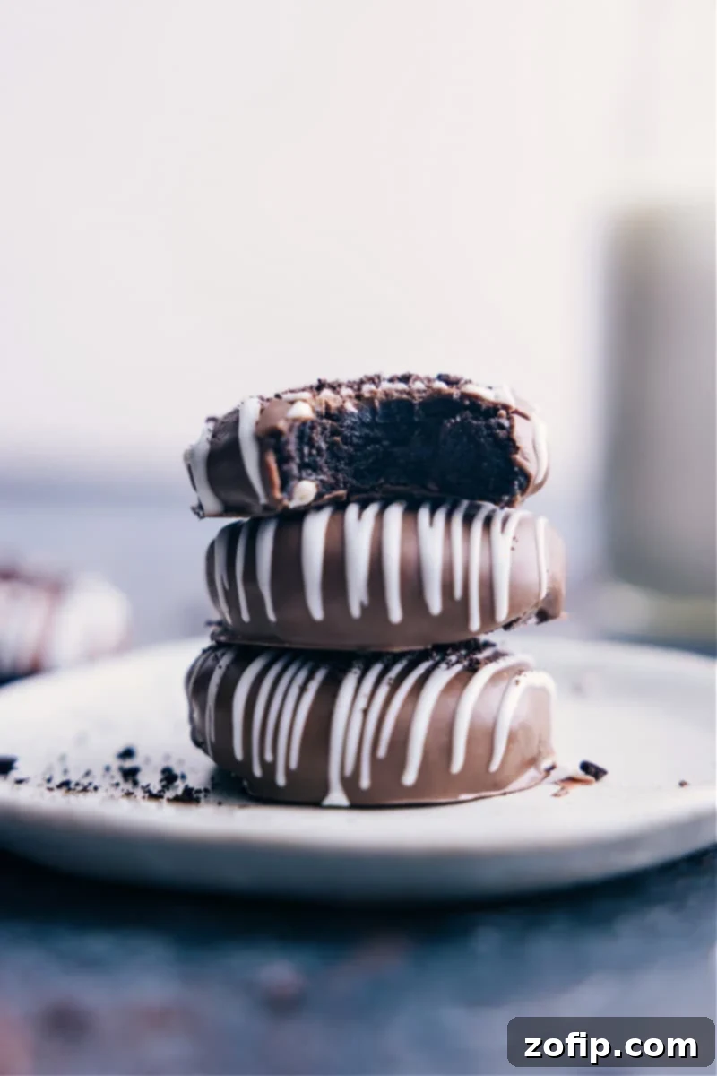 Delicious Oreo Truffles: A simple, no-bake dessert made with only 5 ingredients. Crushed Oreo cookies and cream cheese, dipped in chocolate, and optionally drizzled for a fancy touch. Perfect for any gathering! A stack of perfectly crafted Oreo Truffles, demonstrating their delicious appeal and simple elegance.