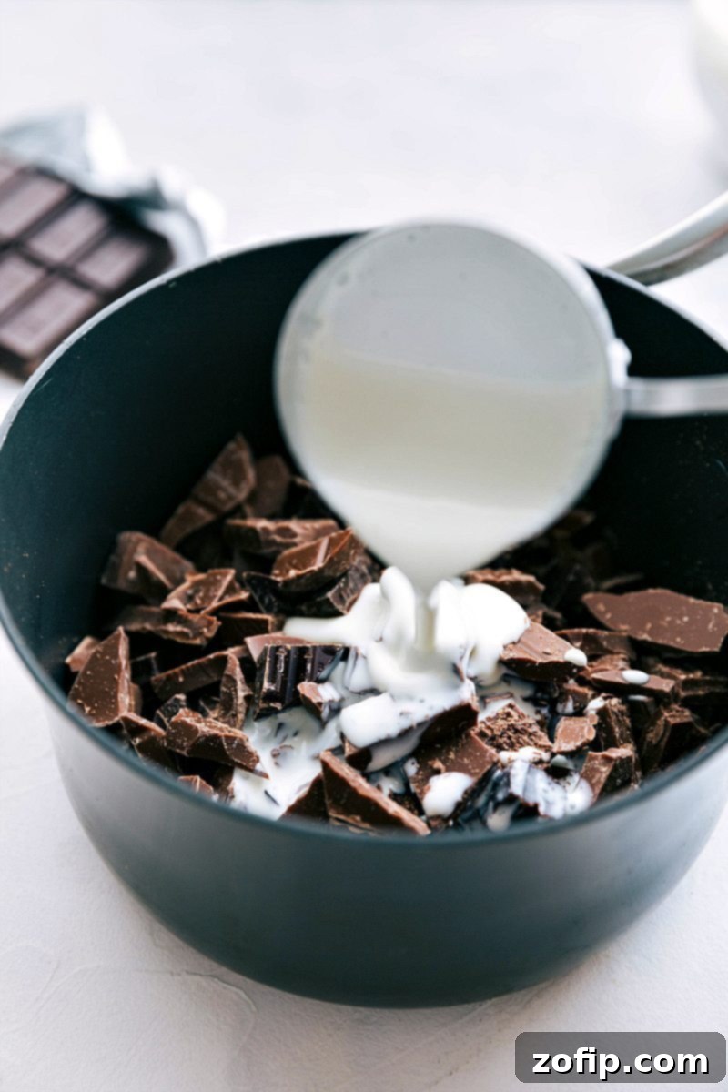 Adding whole milk (or heavy cream) to the pot while melting chocolate for a silky chocolate fondue.