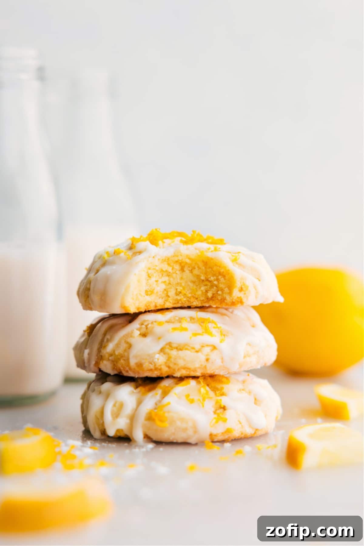 Freshly baked lemon cookies drizzled with lemon glaze on a cooling rack.